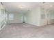 Upstairs loft featuring carpet floors, two windows, and accent wall at 2061 Rush Bay Way, Orlando, FL 32824