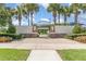 Community park entrance featuring palm trees, stone details, and landscaping at 2061 Rush Bay Way, Orlando, FL 32824