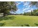 Expansive community park featuring lush green space, playground, and picnic area at 2061 Rush Bay Way, Orlando, FL 32824