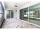 Screened patio with stone pavers, ceiling fan, and access to the backyard at 2061 Rush Bay Way, Orlando, FL 32824