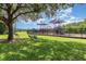 Community playground featuring state of the art equipment, benches, and mature trees at 2061 Rush Bay Way, Orlando, FL 32824