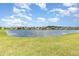 Scenic pond view showcasing waterfront homes in a well-kept neighborhood at 2061 Rush Bay Way, Orlando, FL 32824