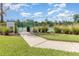 A well-maintained community tennis court with new green fence and court rules sign at 2061 Rush Bay Way, Orlando, FL 32824