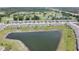 A lovely aerial view of the townhouses beside a large pond and a golf course in the distance at 2450 Sweet Viburnum Way, Ocoee, FL 34761
