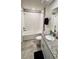 Bright bathroom featuring a shower-tub combo, granite counters, and modern fixtures at 2450 Sweet Viburnum Way, Ocoee, FL 34761