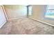 Neutral-toned bedroom featuring plush carpeting, natural light, and fresh paint at 2450 Sweet Viburnum Way, Ocoee, FL 34761