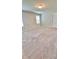 Neutral-toned bedroom featuring plush carpeting, natural light, and fresh paint at 2450 Sweet Viburnum Way, Ocoee, FL 34761