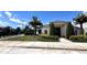 The clubhouse has a landscaped yard, palm trees, and a covered entryway for visitors at 2450 Sweet Viburnum Way, Ocoee, FL 34761