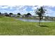 Beautiful townhomes overlooking a pond, complemented by lush green grass and a serene, picturesque setting at 2450 Sweet Viburnum Way, Ocoee, FL 34761