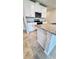 Modern kitchen with white cabinets, granite counters, and stainless steel appliances at 2450 Sweet Viburnum Way, Ocoee, FL 34761