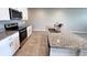Open kitchen with granite island, stainless steel appliances, and white cabinetry at 2450 Sweet Viburnum Way, Ocoee, FL 34761