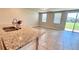 Open-concept kitchen with granite island flowing into a bright, tiled living space at 2450 Sweet Viburnum Way, Ocoee, FL 34761