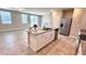 Open kitchen with granite island, stainless steel dishwasher, and a view into the living area at 2450 Sweet Viburnum Way, Ocoee, FL 34761