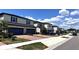 Charming row of two-story homes featuring brick driveways and a well-maintained street view at 2450 Sweet Viburnum Way, Ocoee, FL 34761