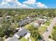 Expansive aerial view of a charming neighborhood with lush green trees and well-maintained homes under a beautiful blue sky at 2460 Worthington Rd, Maitland, FL 32751