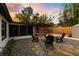 Backyard with a fire pit, four chairs, an outdoor patio with outdoor kitchen, screened-in porch, and privacy fence at 2460 Worthington Rd, Maitland, FL 32751