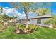 Landscaped backyard featuring a decorative tree, covered deck, and screened porch at 2460 Worthington Rd, Maitland, FL 32751