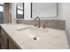 Close up on double sink vanity, marble counter top, and bronze faucet fixtures at 2460 Worthington Rd, Maitland, FL 32751