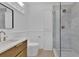 Modern bathroom with walk-in shower, wooden vanity and a marble countertop at 2460 Worthington Rd, Maitland, FL 32751