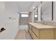 Well-lit bathroom featuring a dual sink vanity with stone countertops and stylish mirrors at 2460 Worthington Rd, Maitland, FL 32751