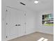 Bright bedroom with hardwood floors, a view, and a closet at 2460 Worthington Rd, Maitland, FL 32751