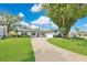 Charming single-story home with a long driveway, well-manicured lawn, and mature trees at 2460 Worthington Rd, Maitland, FL 32751