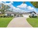 Charming single-story home with a long driveway, well-manicured lawn, and neat landscaping at 2460 Worthington Rd, Maitland, FL 32751