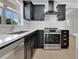 Modern kitchen with stainless steel appliances, black cabinetry, and quartz countertops at 2460 Worthington Rd, Maitland, FL 32751