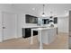Well-lit kitchen featuring dark cabinets, an island, stainless steel appliances, and quartz countertops at 2460 Worthington Rd, Maitland, FL 32751