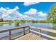 Picturesque lake view from a wooden pier, showcasing tranquil waters and distant shoreline at 2460 Worthington Rd, Maitland, FL 32751