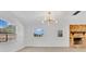 Bright living room with many windows, wood flooring, and modern lighting fixture at 2460 Worthington Rd, Maitland, FL 32751