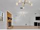 Spacious living room featuring a brick fireplace and modern lighting at 2460 Worthington Rd, Maitland, FL 32751