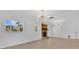 Bright living room featuring a brick fireplace, hardwood floors, and modern light fixtures at 2460 Worthington Rd, Maitland, FL 32751