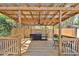 Covered wooden deck featuring built-in grill, ceiling fan and decorative accents for outdoor living at 2460 Worthington Rd, Maitland, FL 32751