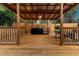 Outdoor patio with wood deck, overhead roof, lighting, fan, outdoor kitchen, and privacy fence for relaxing outdoor living at 2460 Worthington Rd, Maitland, FL 32751