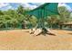 Community playground with slides, swings, and a covered play area in a wooded setting at 2460 Worthington Rd, Maitland, FL 32751