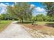 Community walking path features bench seating alongside a gravel trail and grassy areas at 2460 Worthington Rd, Maitland, FL 32751
