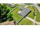 Aerial shot of a home's backyard with a patio, green lawn, and white fence, offering privacy at 2471 Greenwood St, Deltona, FL 32738
