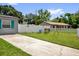 Spacious backyard with a swing set, a white privacy fence, and plenty of room to play at 2471 Greenwood St, Deltona, FL 32738