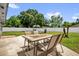 Sunny backyard featuring a patio table set for four on a concrete slab and green grass at 2471 Greenwood St, Deltona, FL 32738