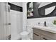 Bathroom featuring modern vanity, black textured wall, and decorative shelving at 2471 Greenwood St, Deltona, FL 32738
