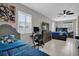 Large, brightly lit bedroom featuring two beds, a ceiling fan, a tv and lots of natural light at 2471 Greenwood St, Deltona, FL 32738