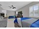 Bright bedroom featuring two beds, ceiling fan, and tile flooring offering a spacious feel at 2471 Greenwood St, Deltona, FL 32738