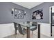 This modern dining area has an art deco wall, modern light fixtures, and a gray color scheme at 2471 Greenwood St, Deltona, FL 32738