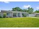 Charming home with a green lawn, inviting front porch, and light blue window shutters at 2471 Greenwood St, Deltona, FL 32738