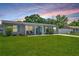 Charming single-story home featuring a lush green lawn and inviting front porch at 2471 Greenwood St, Deltona, FL 32738