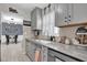 This renovated kitchen has gray cabinets, tile backsplash, and modern fixtures at 2471 Greenwood St, Deltona, FL 32738
