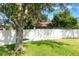 This backyard features a large tree with swing and a soccer goal with white privacy fence at 2619 Breezy Meadow Rd, Apopka, FL 32712