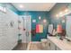 The bathroom features a glass door shower, white subway tiles, and teal accent wall at 2619 Breezy Meadow Rd, Apopka, FL 32712