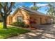 Charming exterior of a home with well-manicured landscaping, a driveway, and an attached garage at 2619 Breezy Meadow Rd, Apopka, FL 32712